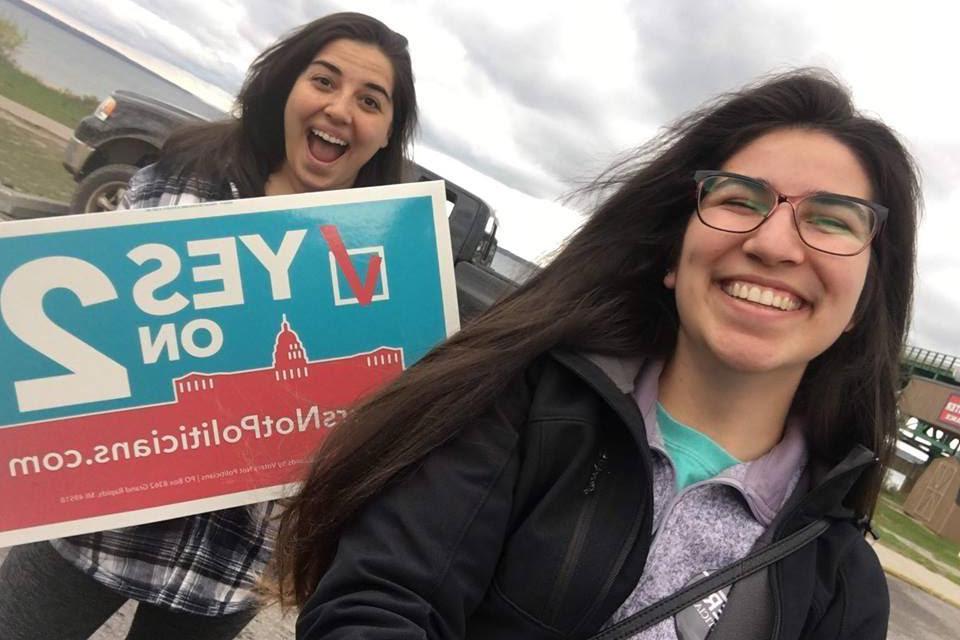 Students with signs That read "Yes on 2"